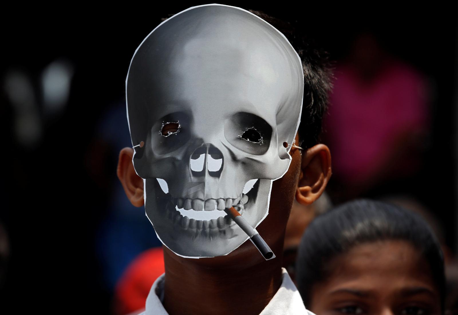 A child wearing a skull mask attends an anti-tobacco awareness rally during the World No Tobacco Day in Kolkata
